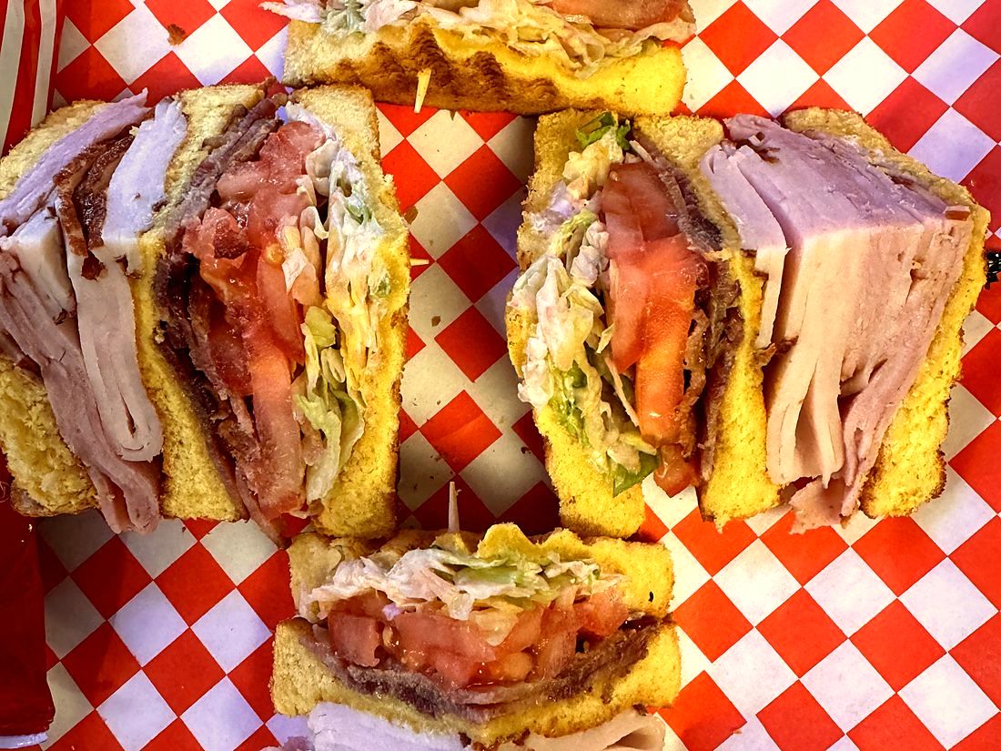 Club sandwich on red checkered paper