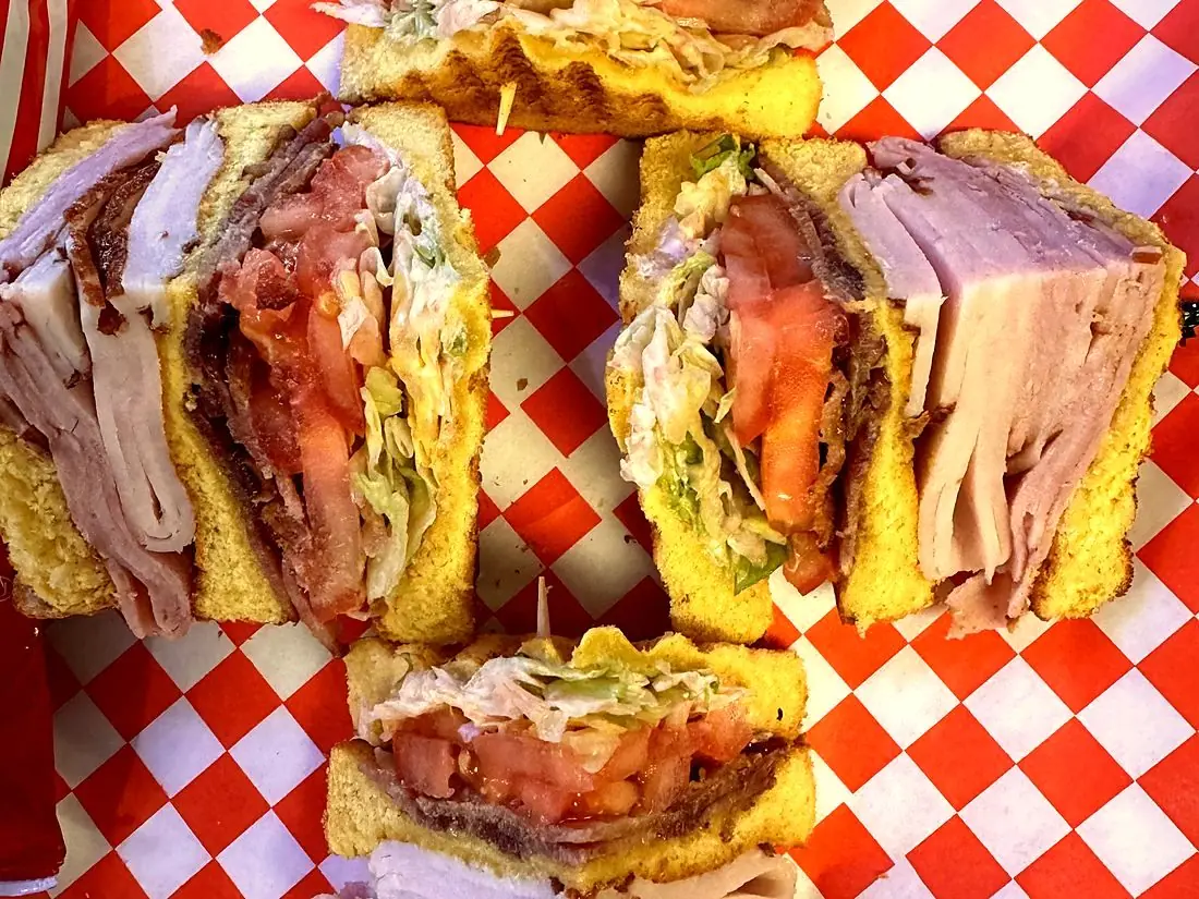 Club sandwich on red checkered paper