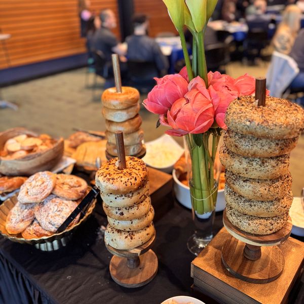 Bagel towers and flowers on a catered breakfast table