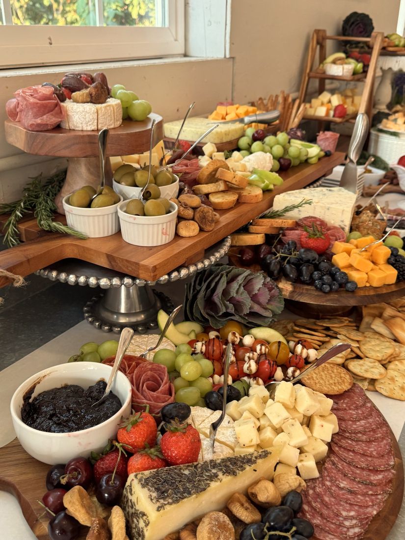 A grazing table with charcuterie, cheeses and fruit