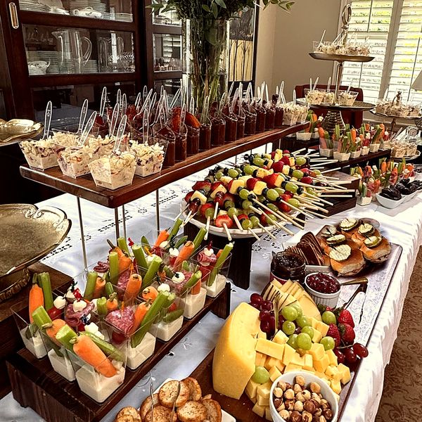 A styled buffet with sliders, skewers and flowers