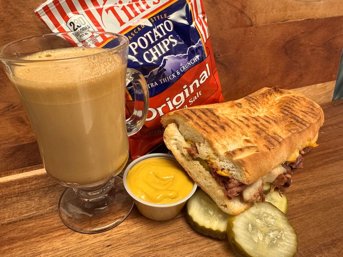 Panini with chips, pickles and a latte